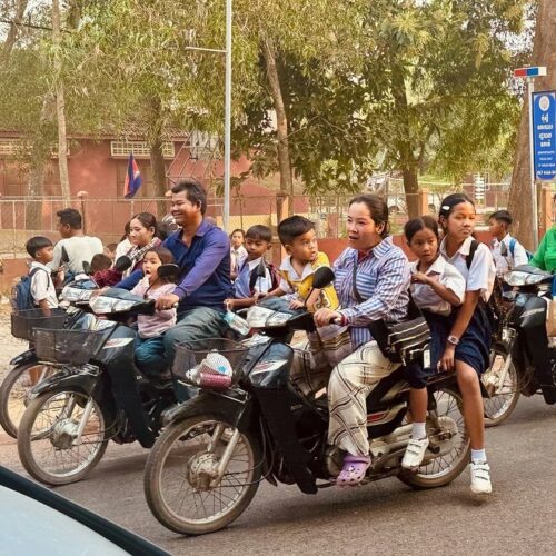 Parents taking their children to school